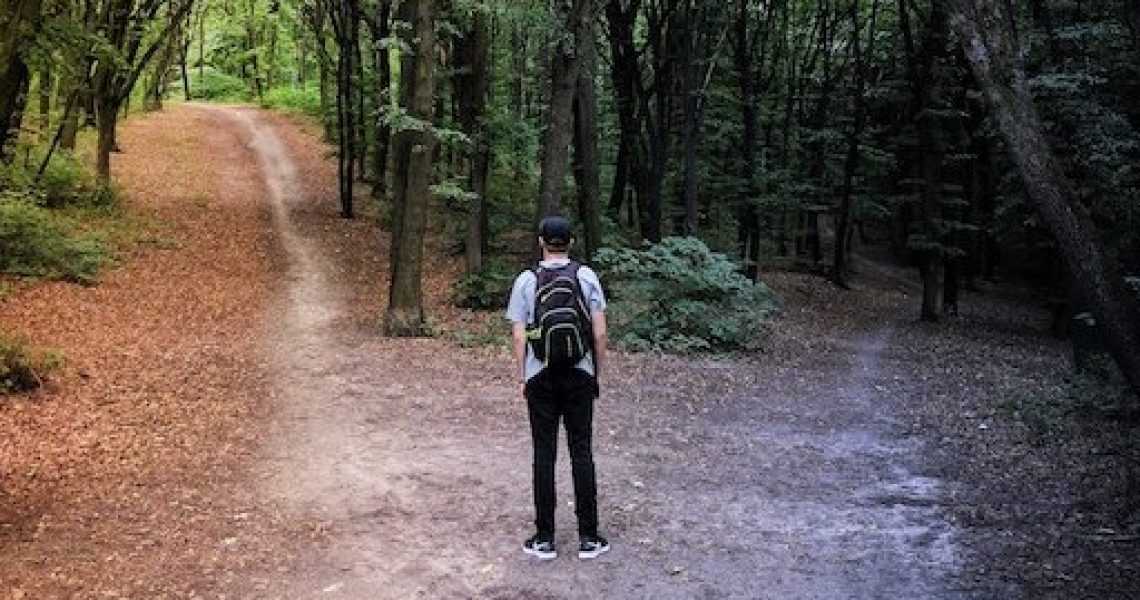 uncertainty hiker at crossroads vladislav-babienko-KTpSVEcU0XU-unsplash